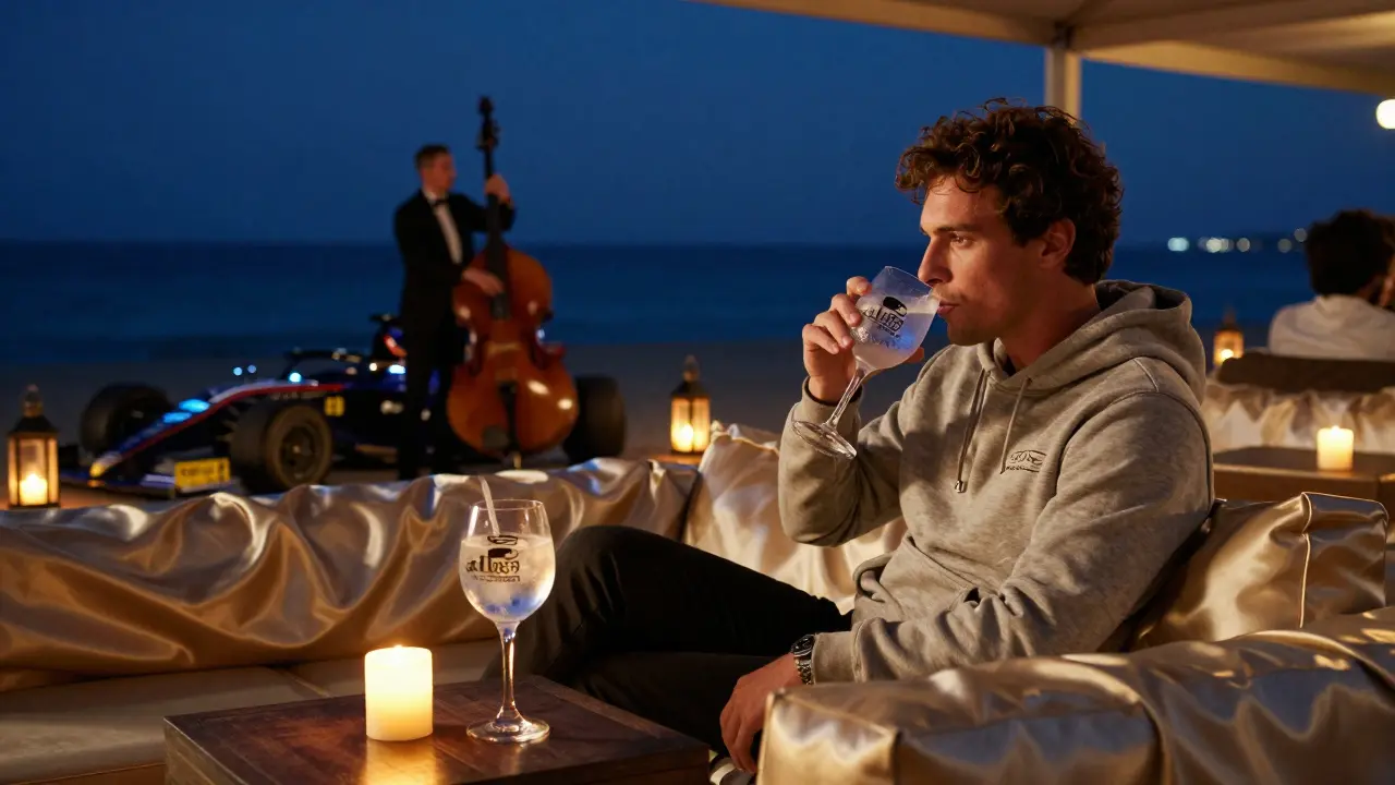 A Formula 1 driver in a hoodie sipping a drink at Club 55 beach lounge, live music and candlelight under the stars.
