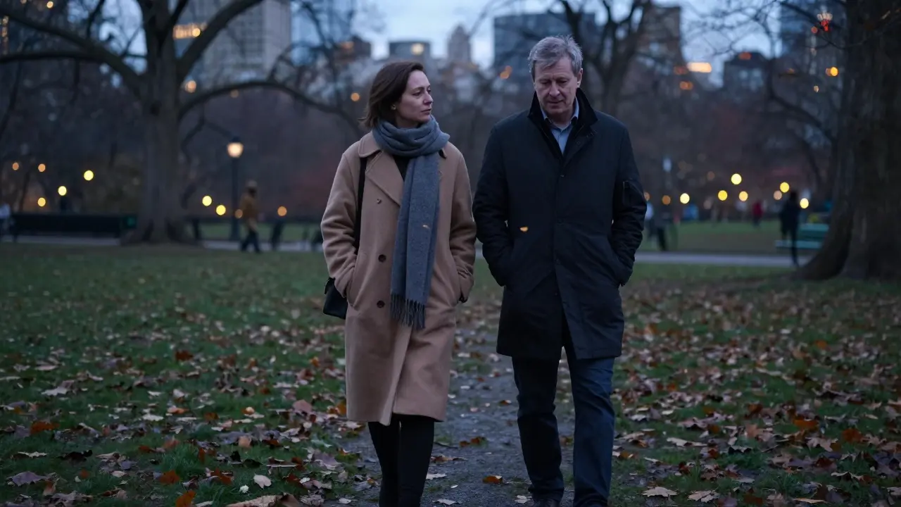 A man and woman walk silently together through Hyde Park at dusk, surrounded by falling leaves.