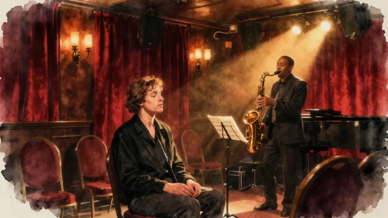 A quiet listener at Ronnie Scott’s jazz club, bathed in spotlight as a saxophonist plays on stage.