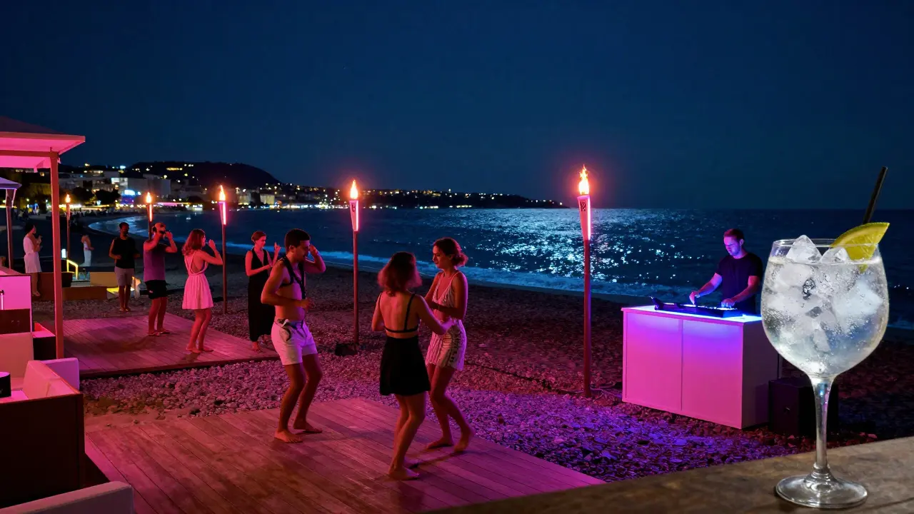 Guests dance barefoot at L’Etoile beach club under neon lights, with the Mediterranean glowing behind them and tiki torches casting warm shadows.