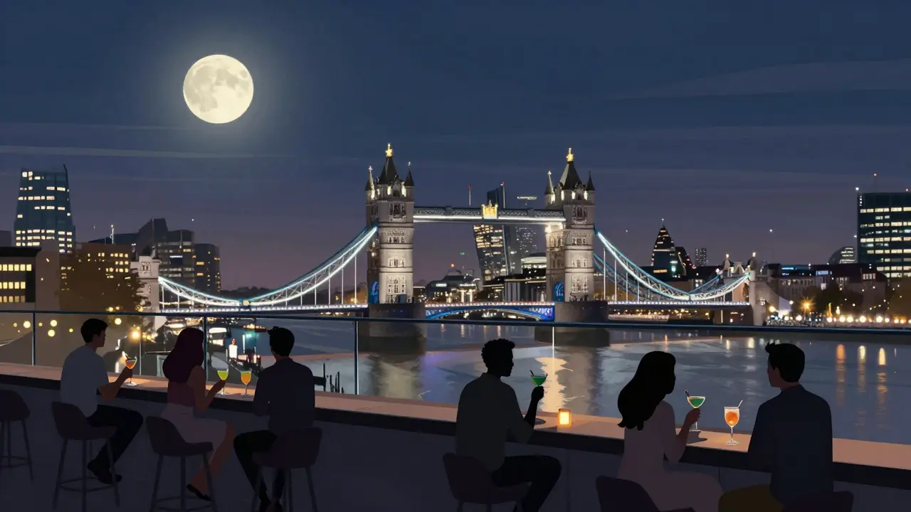 People enjoying cocktails on a rooftop bar with views of London's illuminated skyline at night.